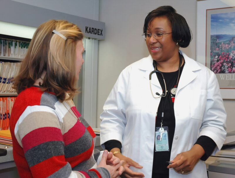 A doctor discusses a case with a patient