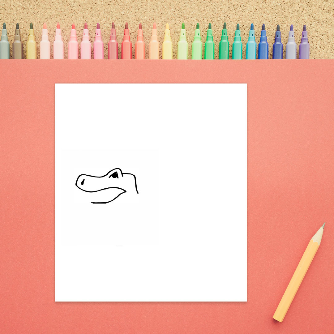 The top of a dinosaur's head is shown. There is an eye, an elongated nose, and the beginning of a mouth in this third step of how to draw a dinosaur.
