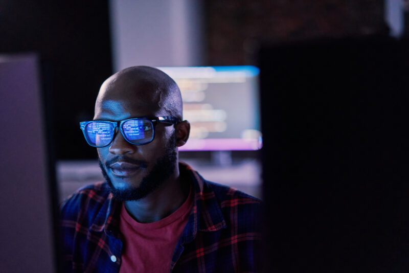 Cyber security, and code reflection in eyewear, hacking and software update in office.