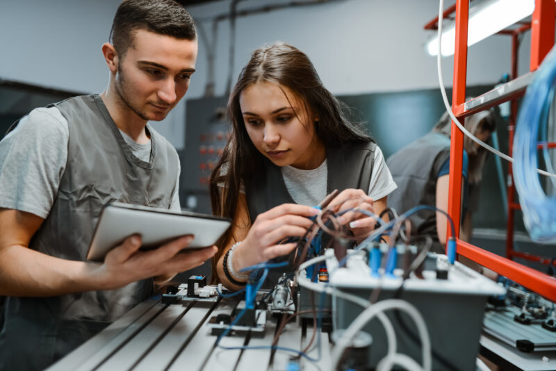 Engineering Students Learning About Diagrams To Connect PLC Devices