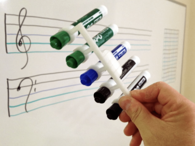 Parallel Line Drawer. 5 markers are seen being held together by a white holder as an example of 3D printing ideas