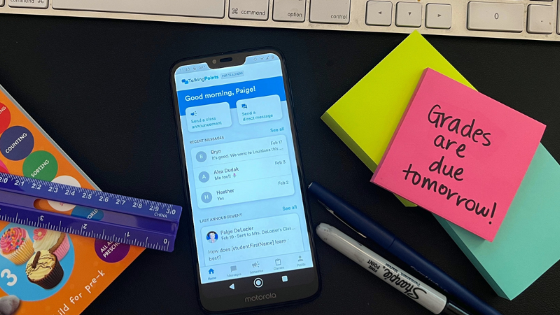 TalkingPoints App TalkingPoints app on cell phone screen which is on a teacher's desk with supplies.