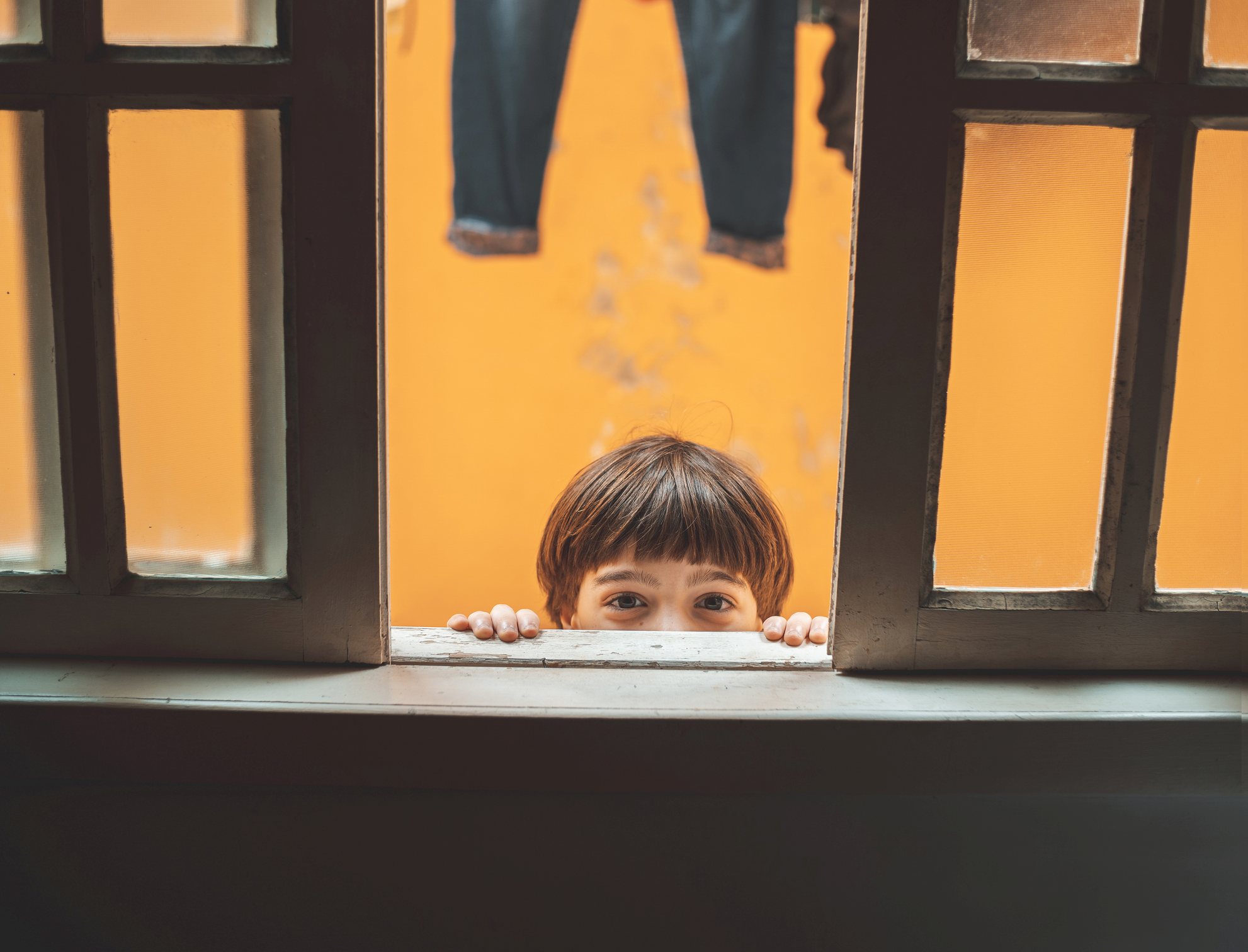 Picture Prompts: Peekaboo Child peeking out the window, looking at the camera.