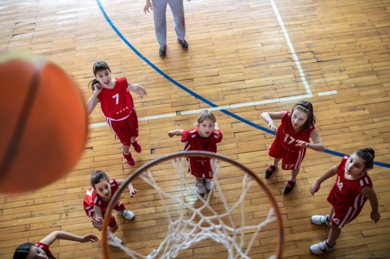 Picture Writing Prompts: Hoop Dreams Female School Basketball Team waiting to see if ball goes in the basketball hoop