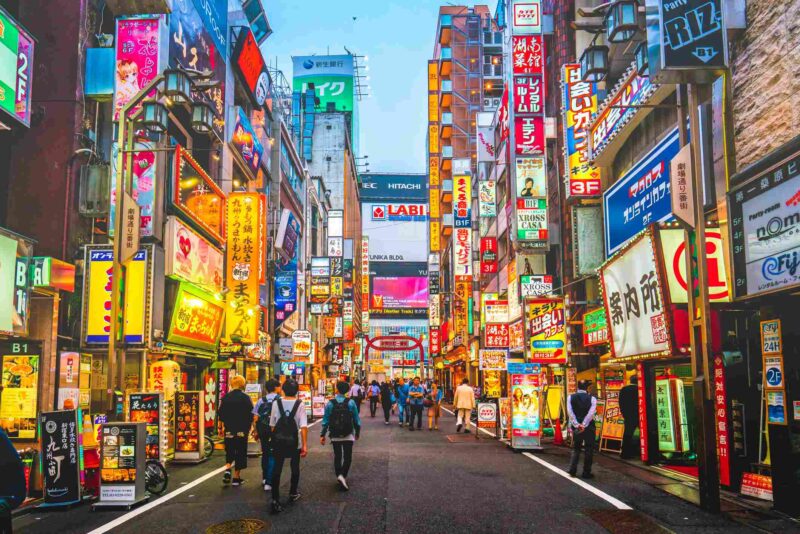 Picture Prompt: Tokyo Street Kabukicho pass illuminated at night in Shinjuku district, Tokyo. The area is a commercial an entertainment zone