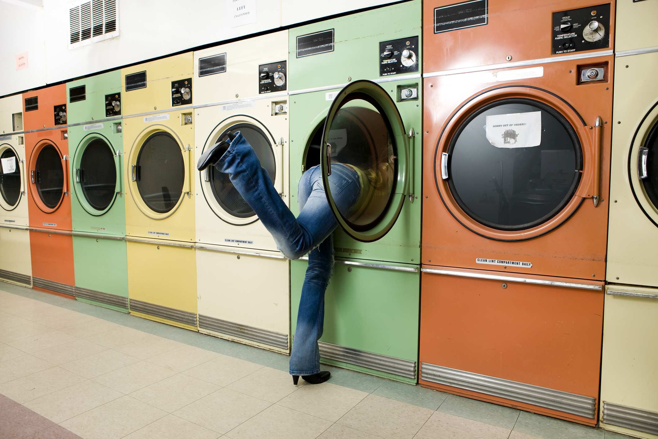 Picture Prompts: Laundromat Girl Leaning into Laundromat Washer to Get Clothes
