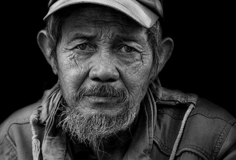 Picture Prompt: Old Age Old man with a weathered face wearing a baseball cap