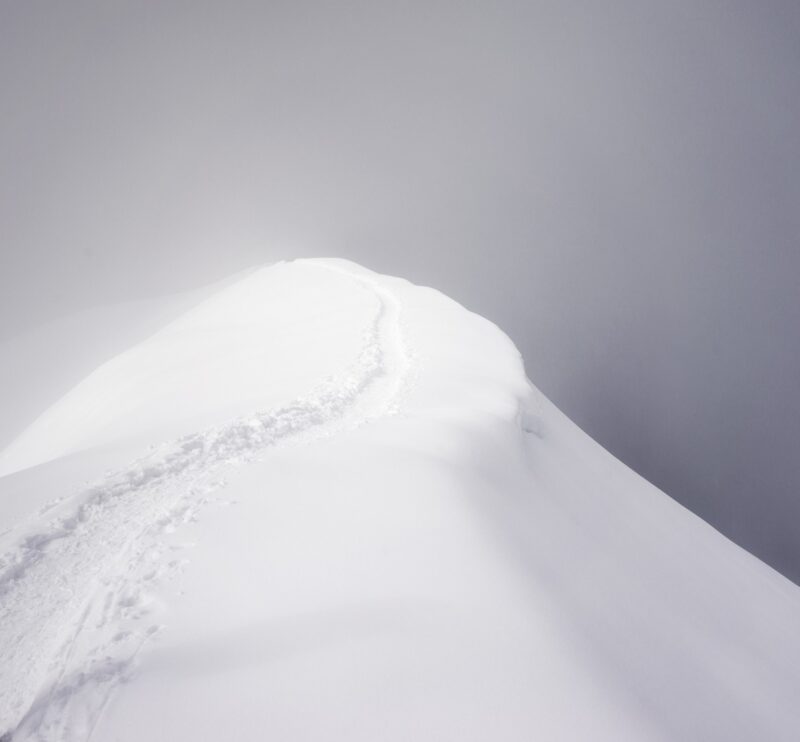 Writing Prompts: Snowy Path A narrow footpath on an alpine mountain ridge surrounded by thick cloud.