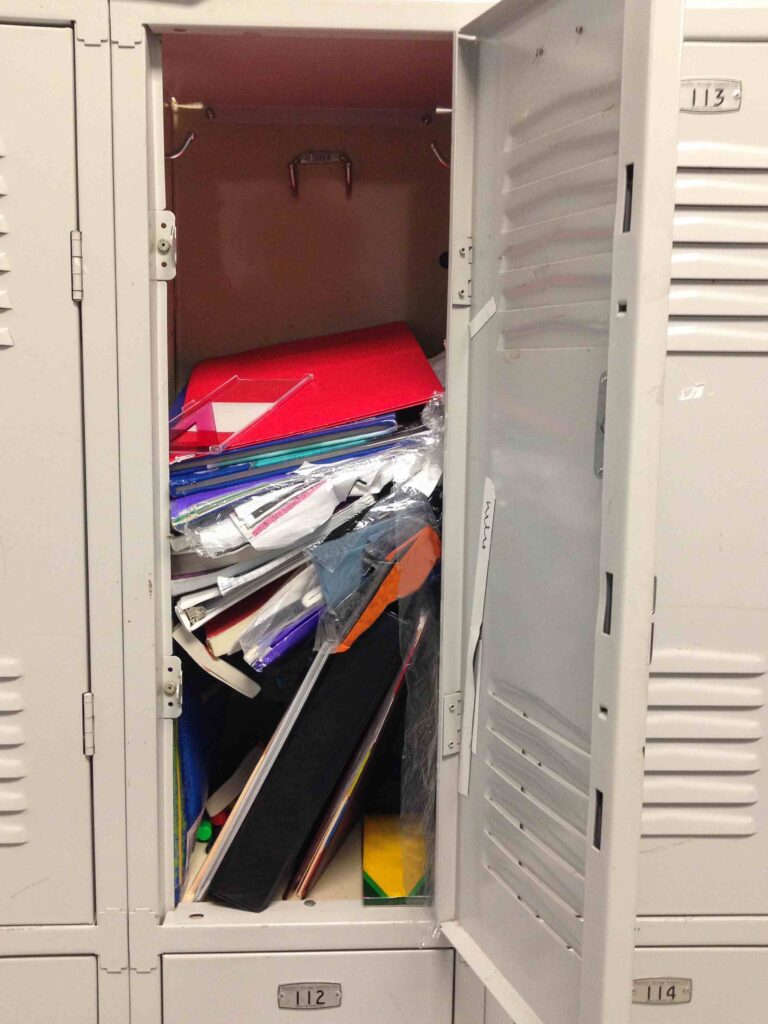 Picture Prompts: Messy Locker Open school locker showing a messy stack of books and papers inside