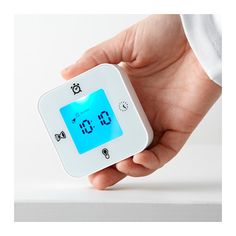 Ikea classroom ideas: A hand is shown holding a small white square timer/clock/thermometer.