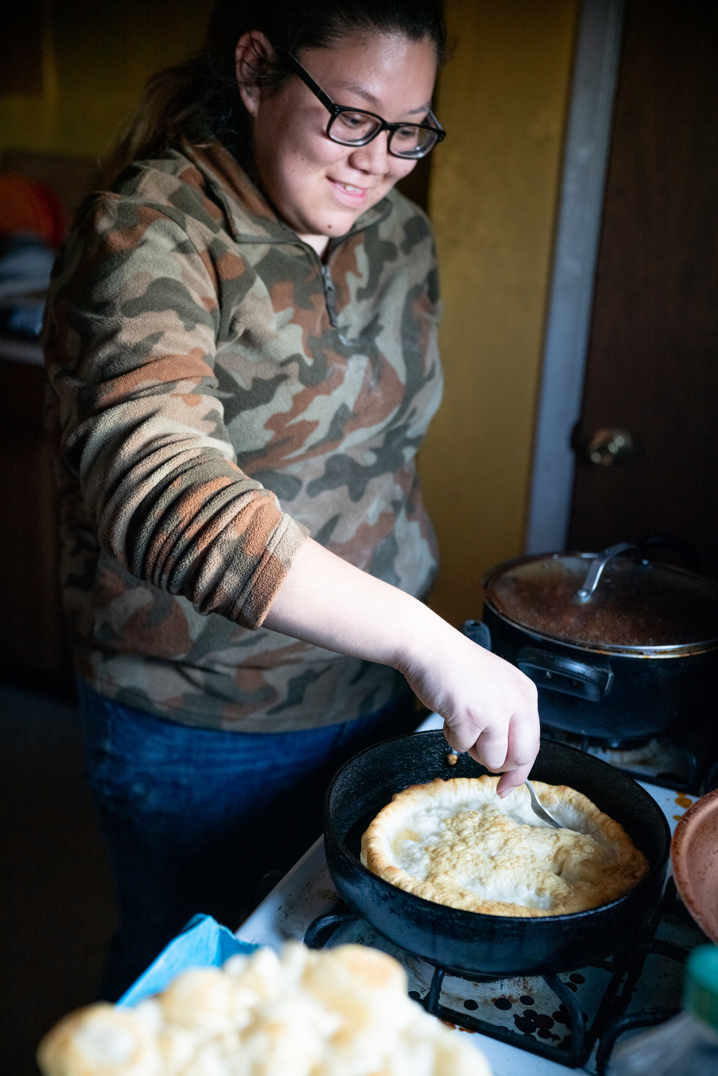Honoring Indigenous Peoples’ Day in the Classroom A smiling young woman making Navajo fry bread