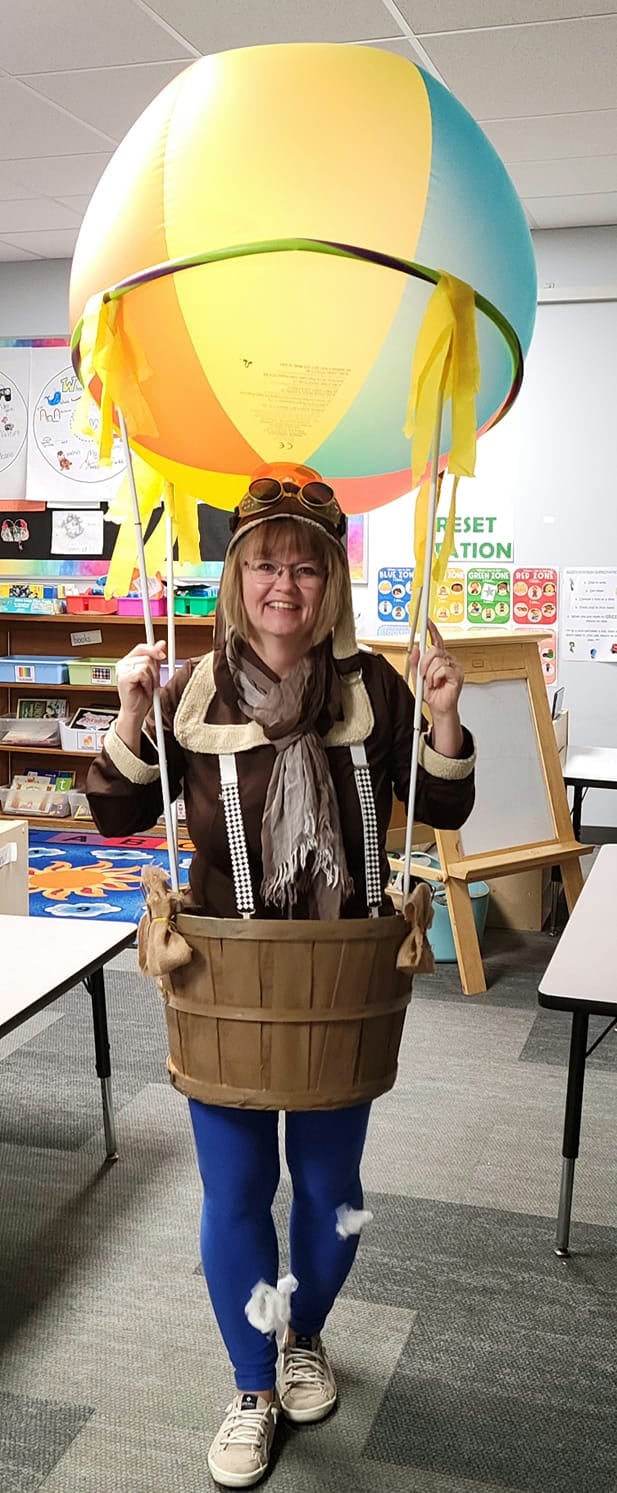 Teacher dressed as Phileas Fogg in a hot air balloon costume for Halloween
