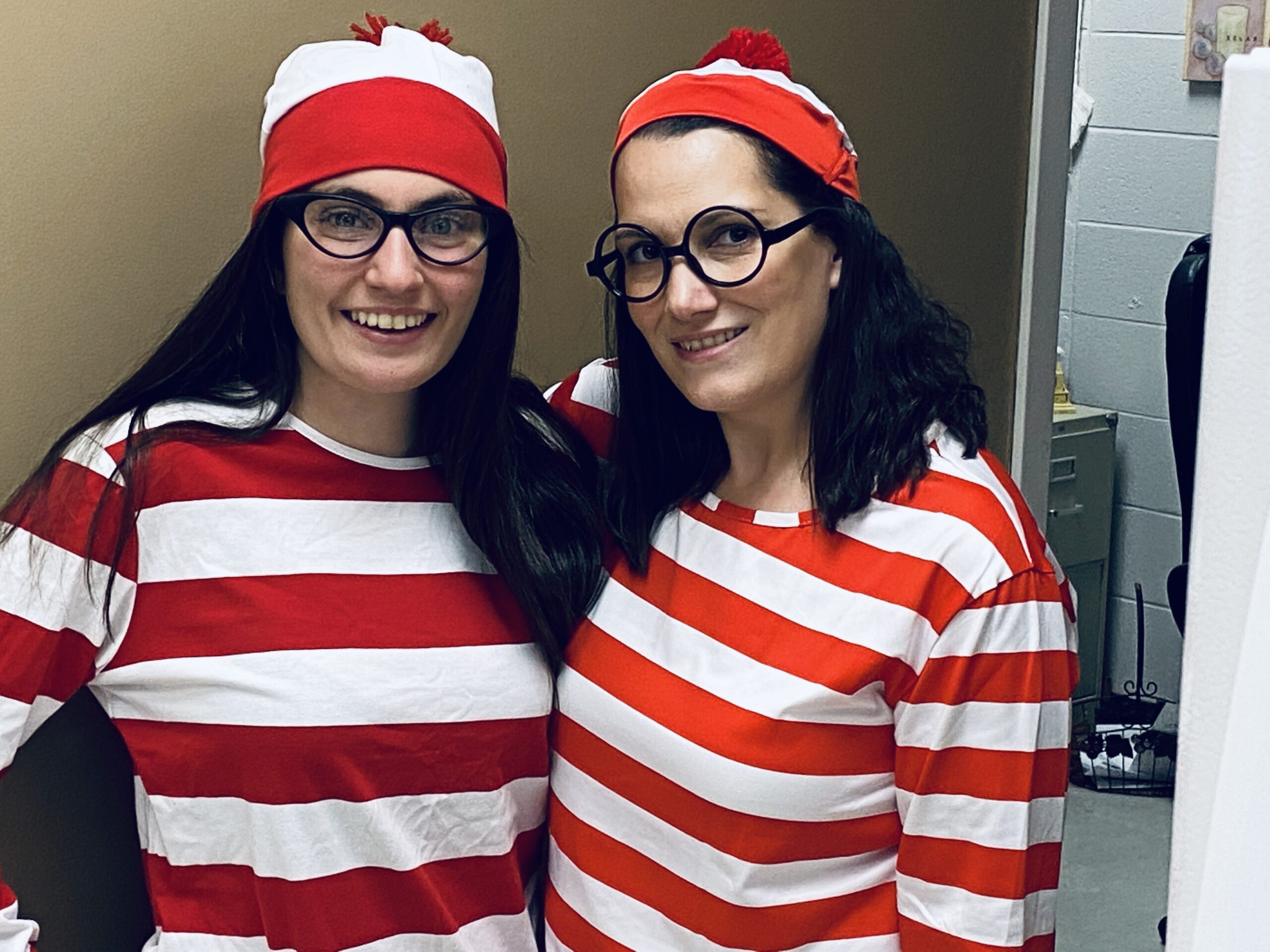 Teachers dressed in striped shirts in hats as Where's Waldo?