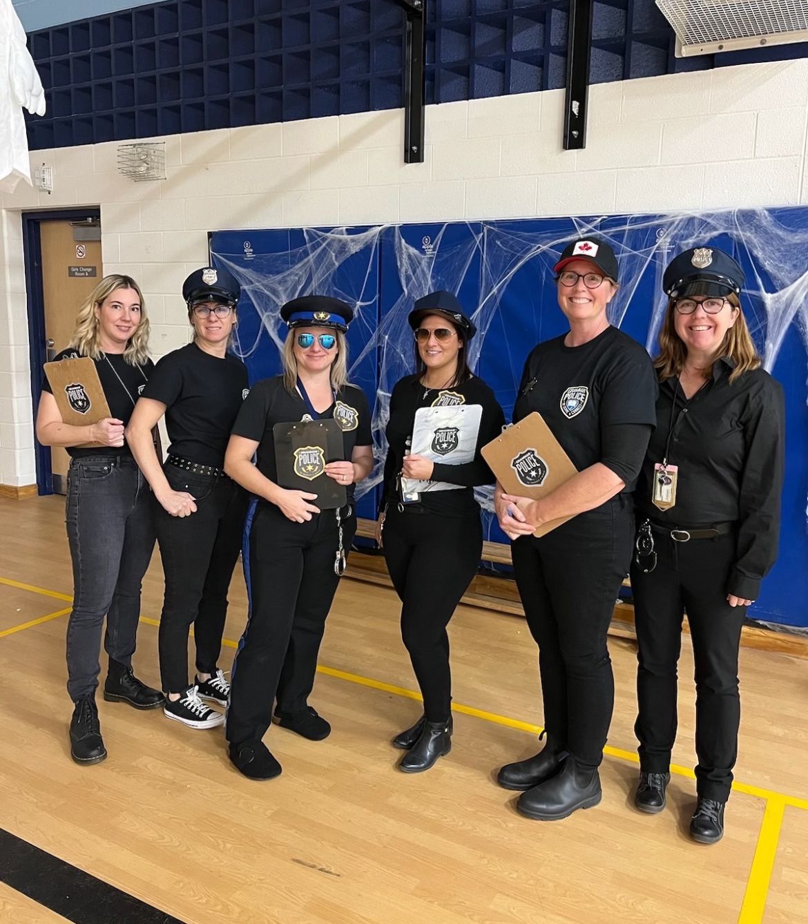 Group of teachers dressed in police uniforms as the Grammar Police