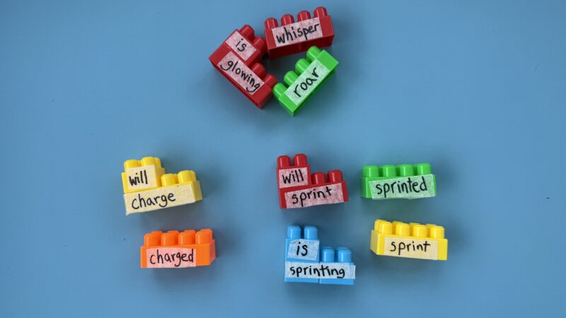 LEGO Verb Match with colorful legos with words written on them