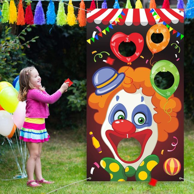 Carnival Games: Clown Toss Child throwing a beanbag into the open mouth of a clown printed on a vinyl banner