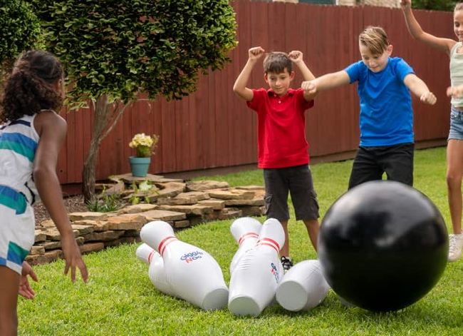 Carnival Games: Giant Bowling Kids playing with a giant inflatable bowling set outside on a lawn
