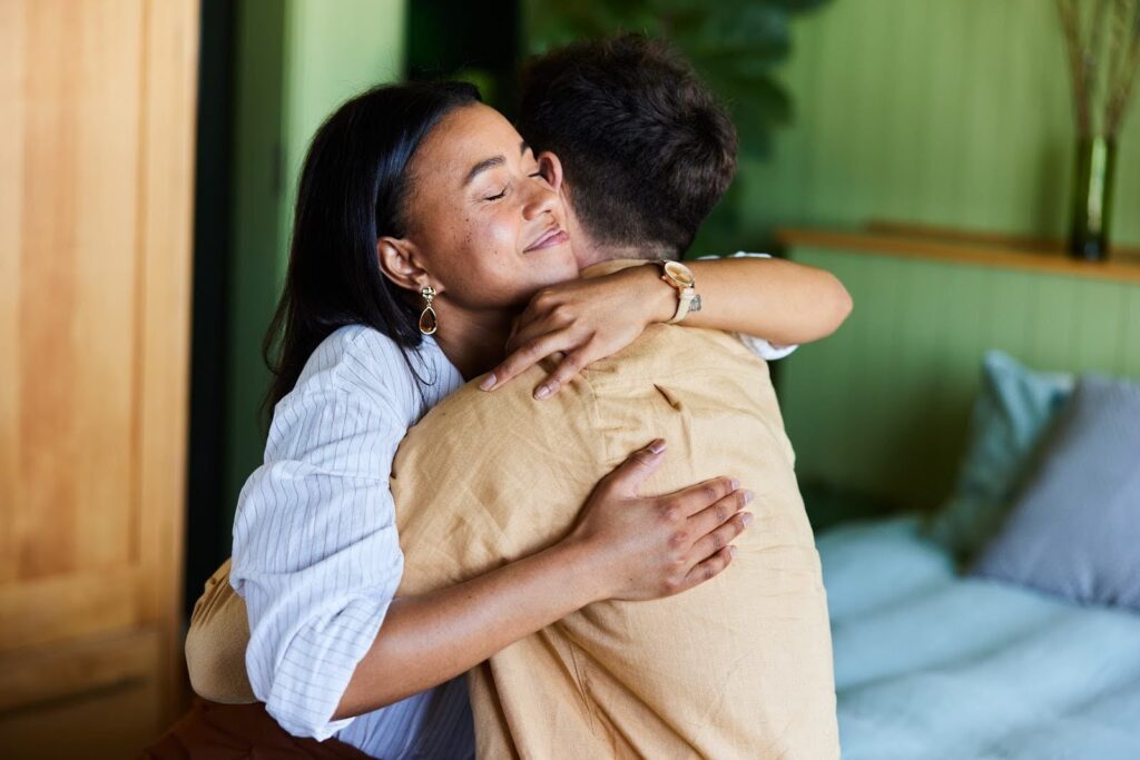 Two people hugging each other.