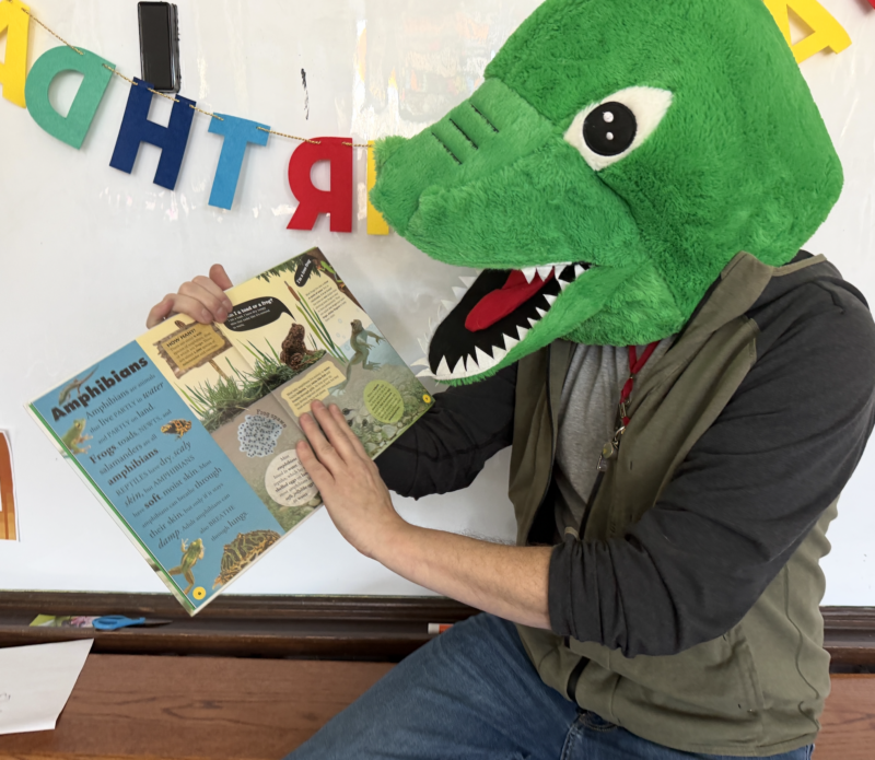 dinosaur teacher with book