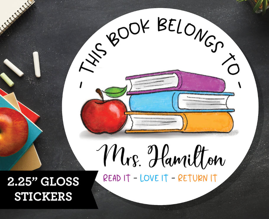 Round sticker with images of books and an apple. Text Reads This Book Belongs to Mrs. Hamilton. Read It. Love It. Return It.