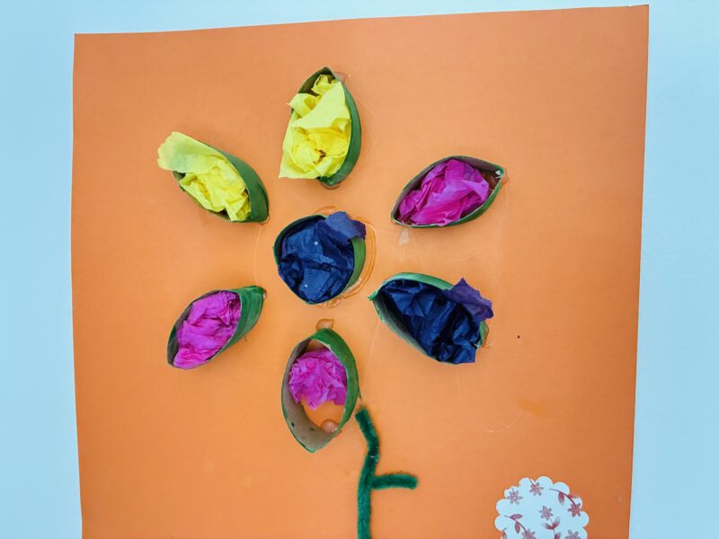 Summer Crafts for Kids a summer craft for kids that involves creating a flower with a cardboard roll and tissue paper