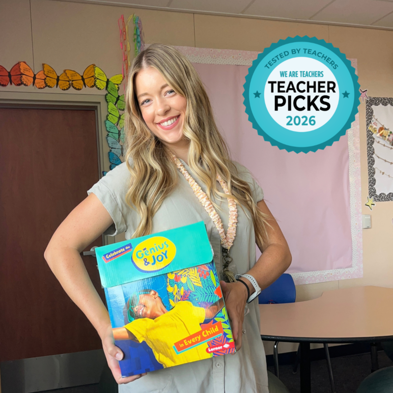 Lerner Genius & Joy – Teacher Holding Curriculum Box Teacher holding Genius & Joy curriculum box in classroom.