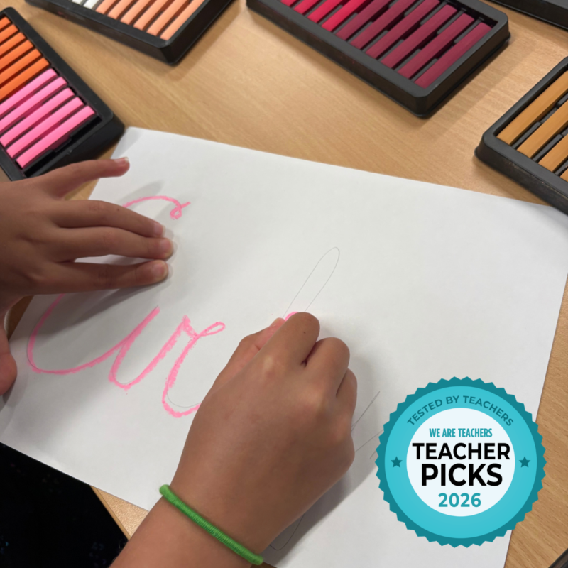 School Specialty School Smart – Chalk Name Plates Student writing name on white paper in colored chalk.