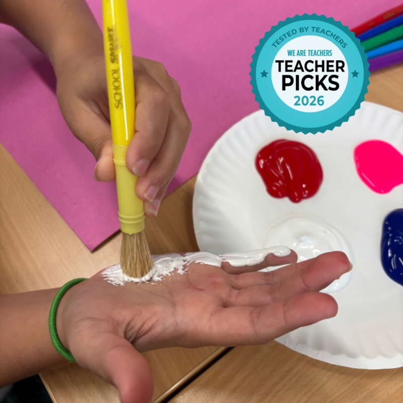 School Specialty School Smart Painting on Hand Student using a School Smart paint brush to apply white paint on the palm of their hand.